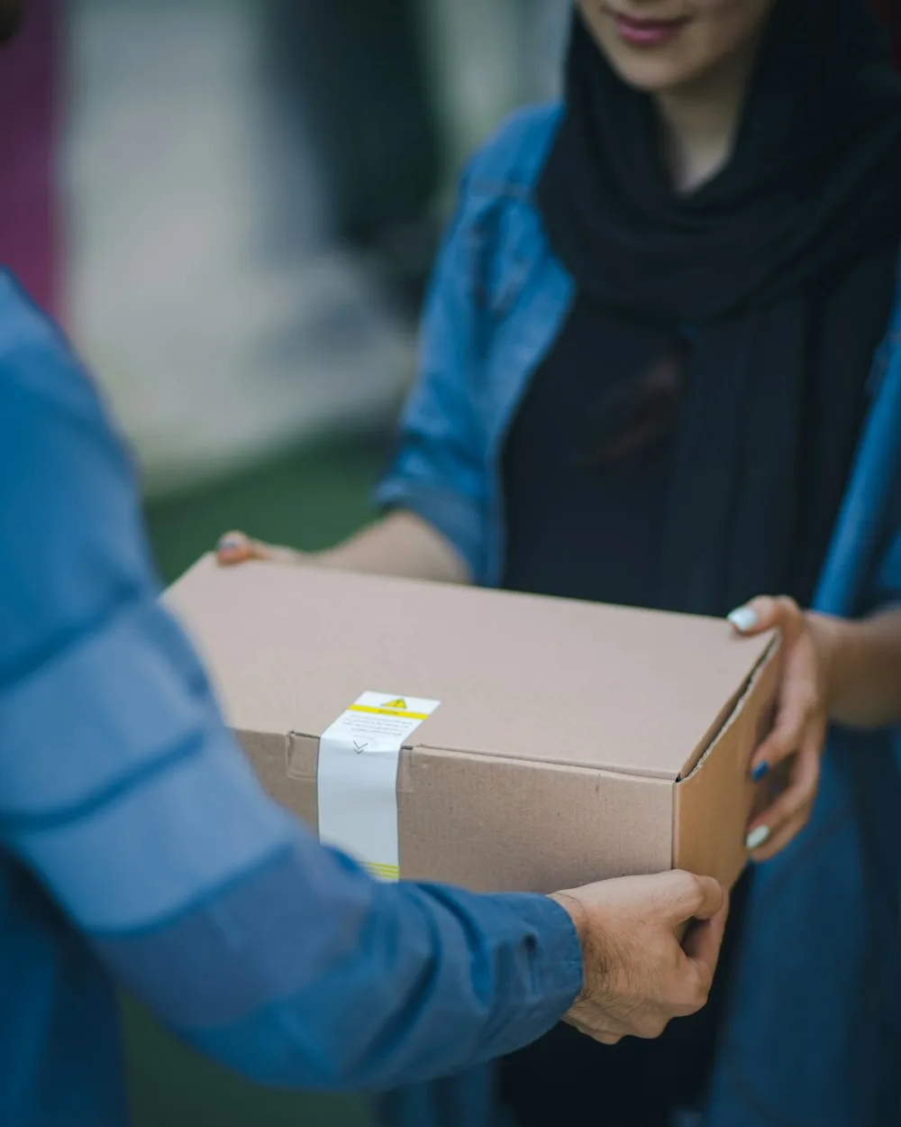 A customer in Bangladesh receiving a forwarded parcel at their door from WOOW Ship For Me